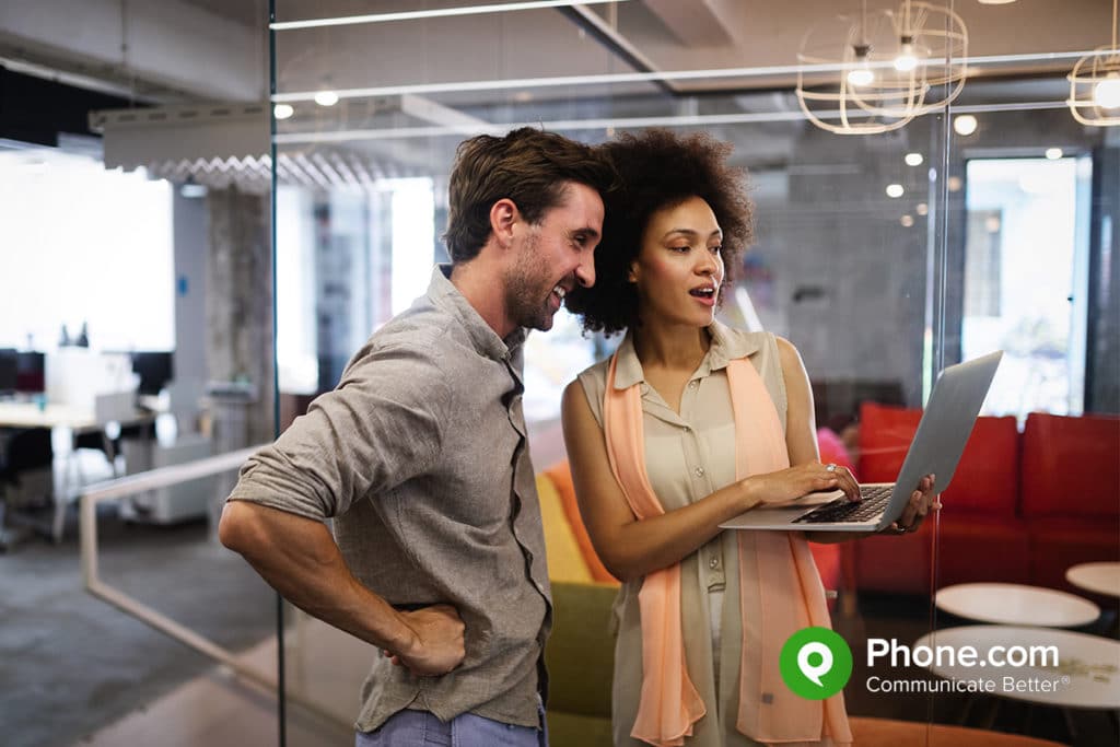 two people looking at collaboration tools in the office