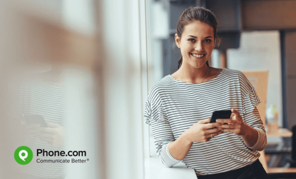 Young business woman with mobile phone.