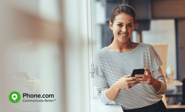 Young business woman with mobile phone.