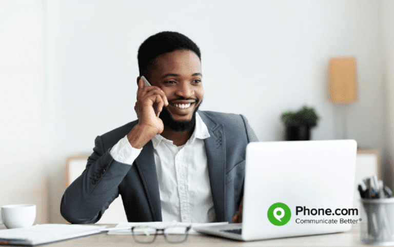 Young man working from home on a mobile phone.