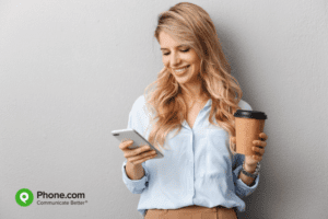 Young woman looks at mobile phone.