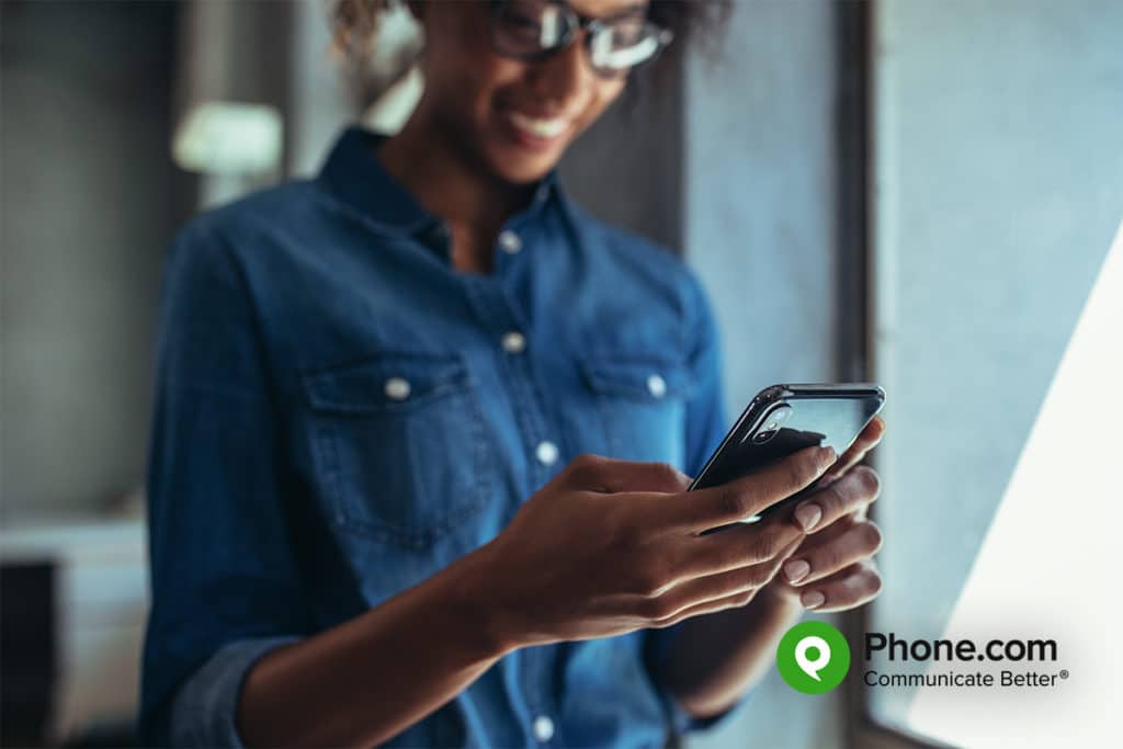 Woman working on a mobile phone.