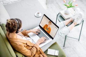 Business woman having a video call with coworker, working online from home at cozy atmosphere. Concept of remote work from home