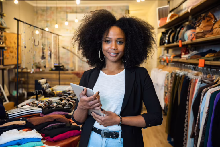 Portrait of the owner of a clothing store at the entrance of the