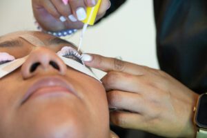Stylist works gently with lashes during lifting process